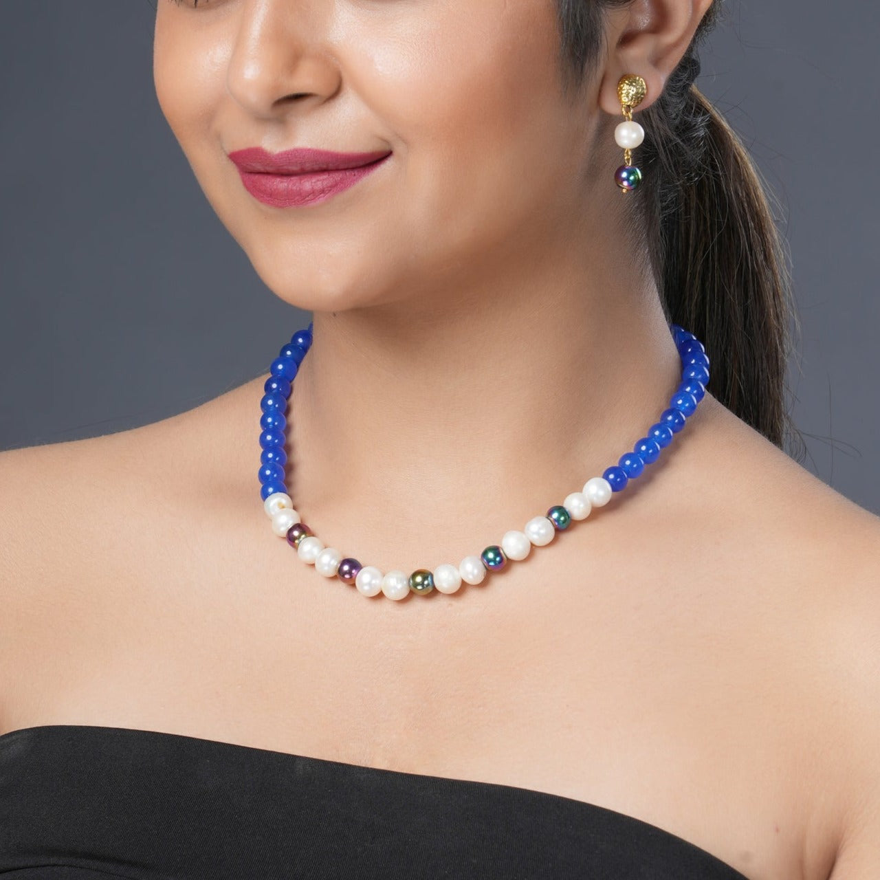 Girl Model Wearing Eykaa Blue Onyx, Rainbow Hematite, And Freshwater Pearl Necklace With Earrings.