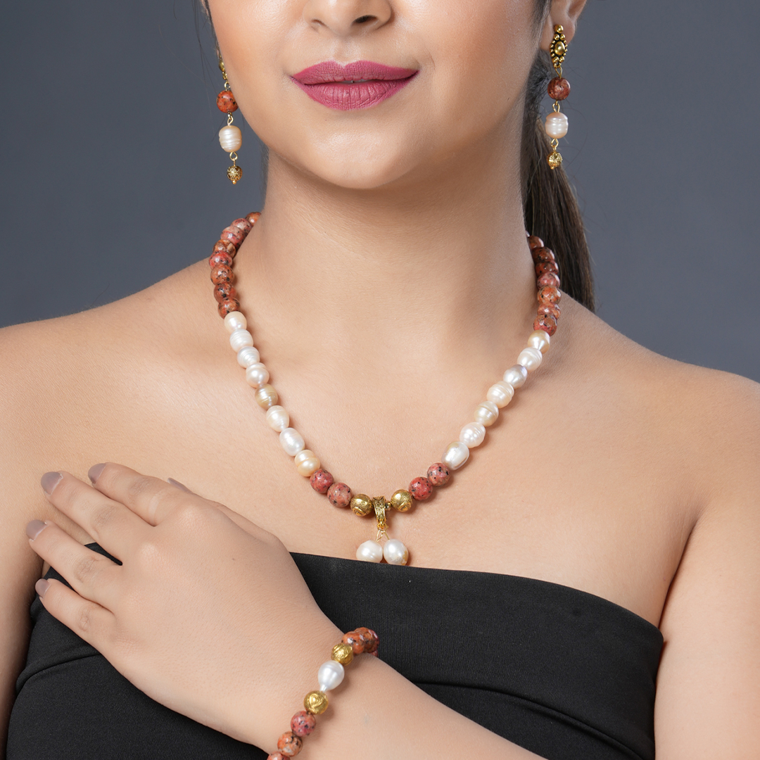 Girl Model Wearing Eykaa Orange Dalmatian And Freshwater Pearl Necklace With Earrings And Bracelet.