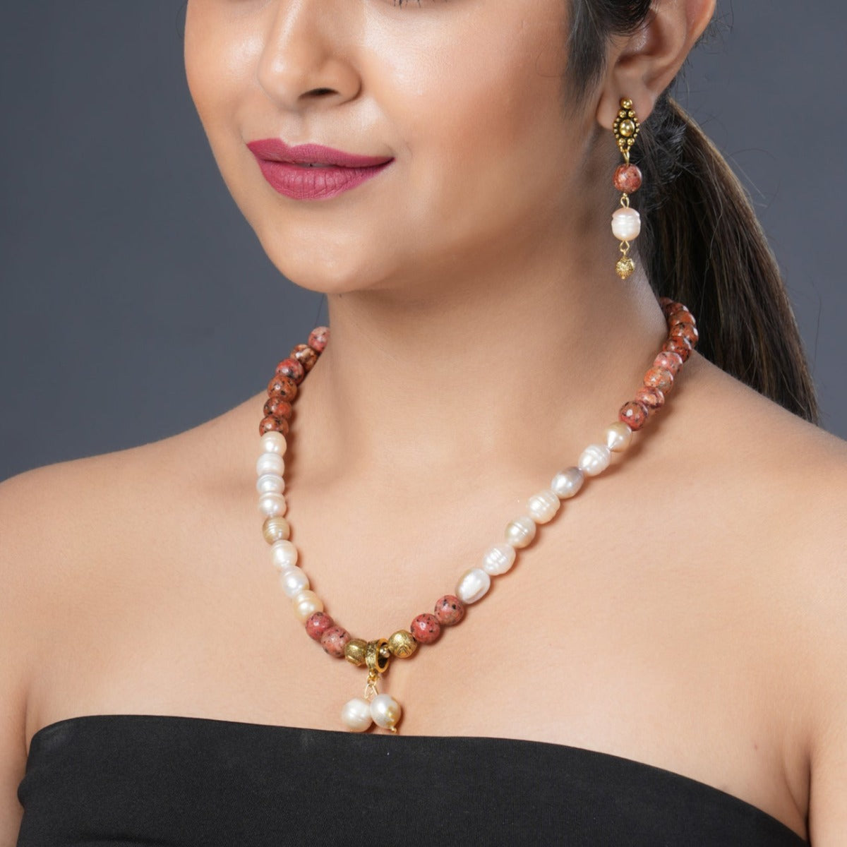 Girl Model Wearing Eykaa Orange Dalmatian And Freshwater Pearl Necklace With Earrings.