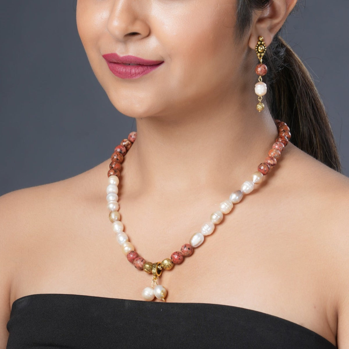 Girl model Wearing Eykaa Orange Dalmatian And Freshwater Pearl Necklace With Earrings.