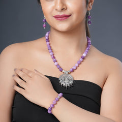 Girl model wearing Eykaa necklace, earrings and bracelet that features EYKAA PURPLE JADE BRACELET