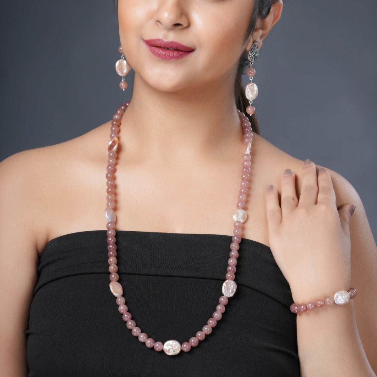 Girl Model Wearing Eykaa Strawberry Quartz and Freshwater Pearl Necklace with Earrings and a Bracelet.