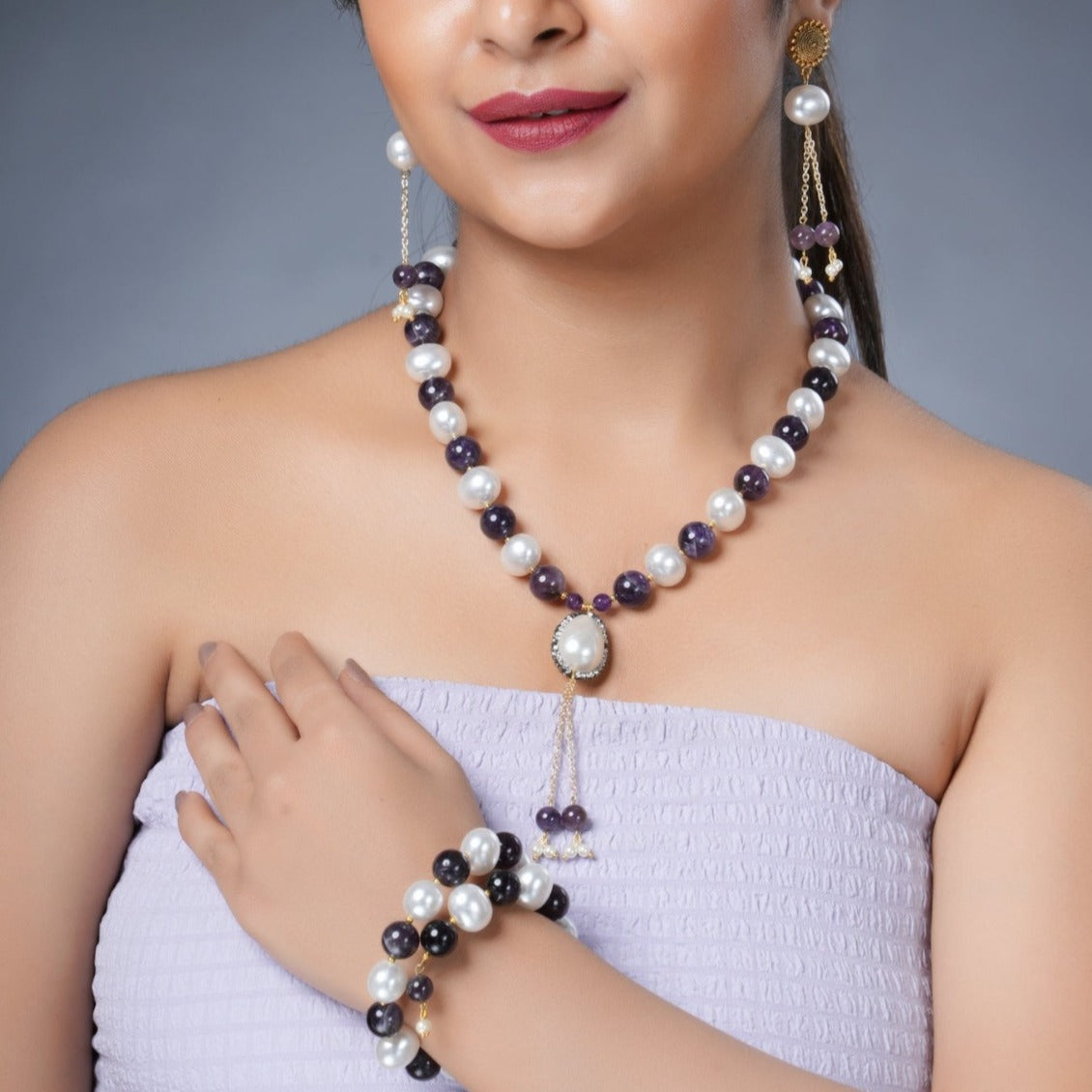 Girl Model Wearing Eykaa Amethyst with Pearl Korean Balls and Shell Pearl Pendant Necklace with Earrings and a Bracelet.