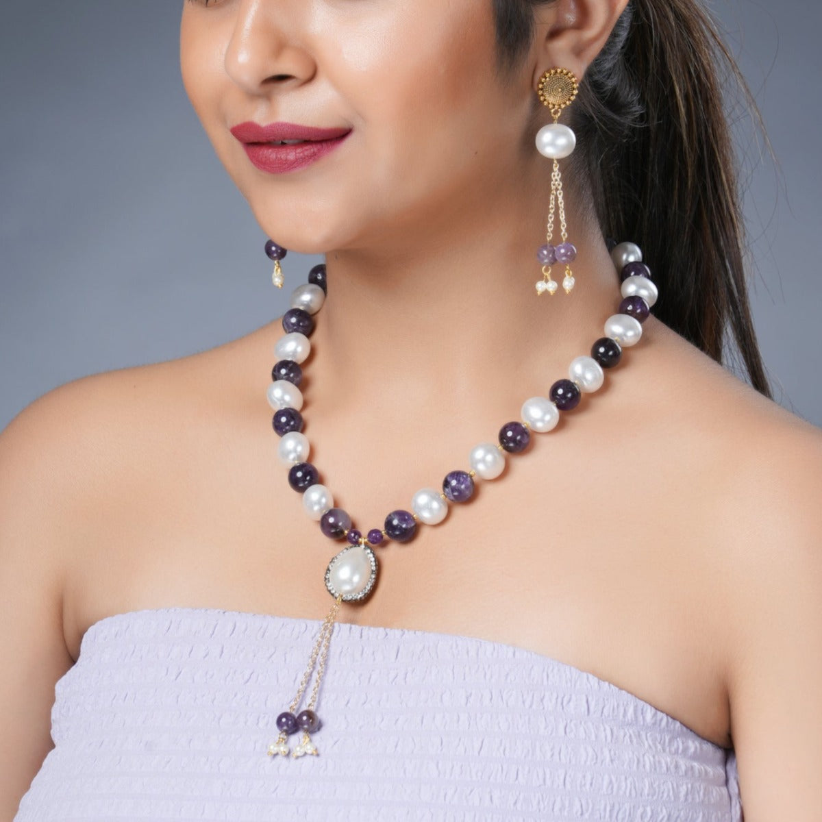 Girl Model Wearing Eykaa Amethyst And Korean Pearl Balls With Shell Pearl Necklace With Earrings.