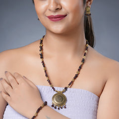 Girl model wearing Eykaa necklace, earrings and bracelet that features EYKAA GARNET WITH GOLDEN CHARMS AND GOLDEN PENDANT BRACELET