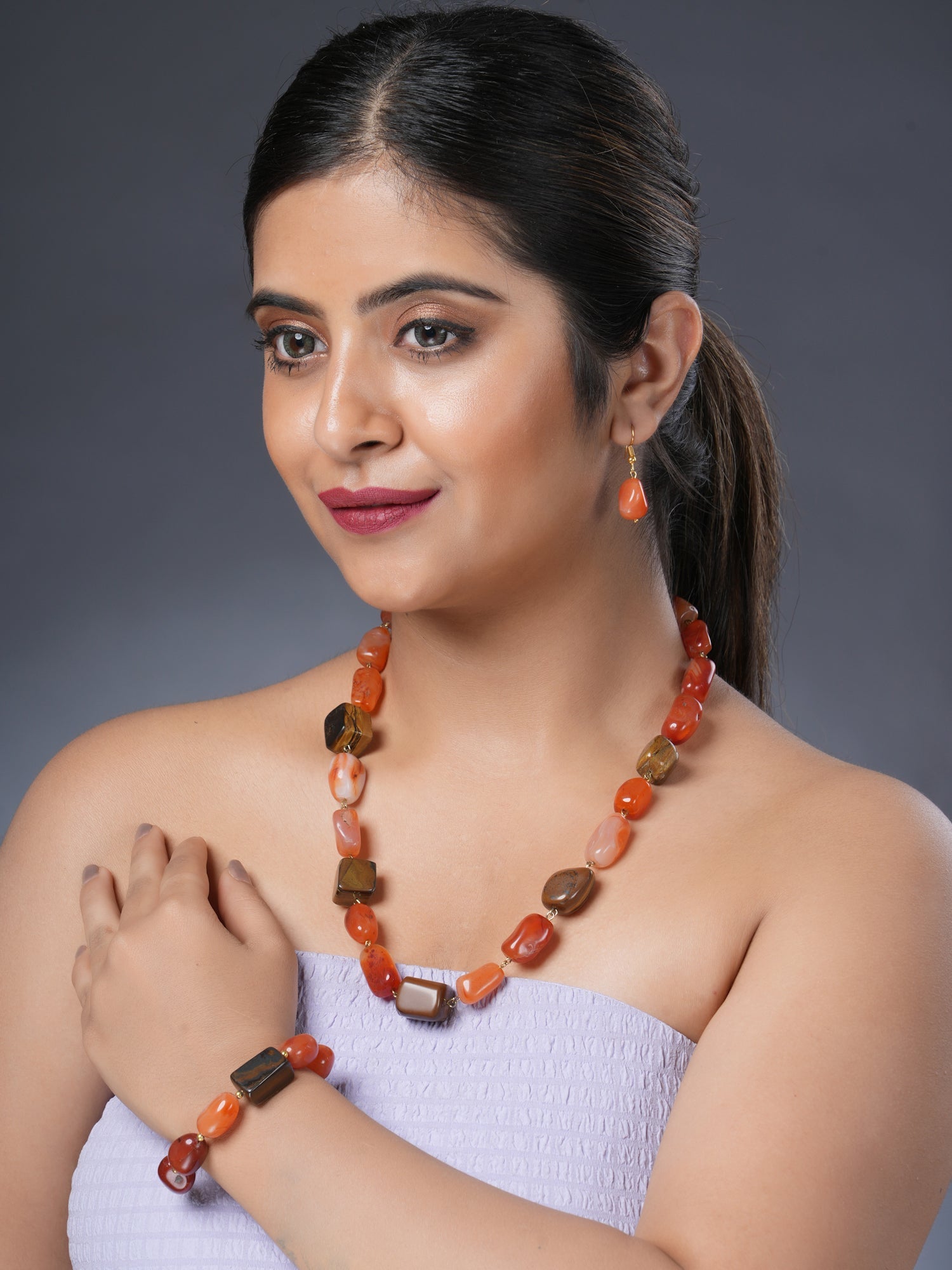 Girl model wearing Eykaa necklace, earrings and bracelet that feature Tiger Eye and Leon Tumble semi precious stones.

Eykaa
stone jewellery
womens jewellery
earing for women
bracelet for women
necklace for women
jewellery stores

