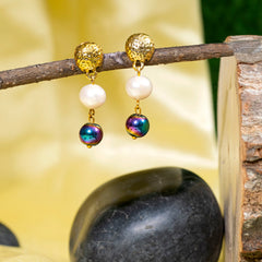 Eykaa Blue Onyx, Rainbow Hematite, And Freshwater Pearl Earrings Hanging On The Tree Branch.