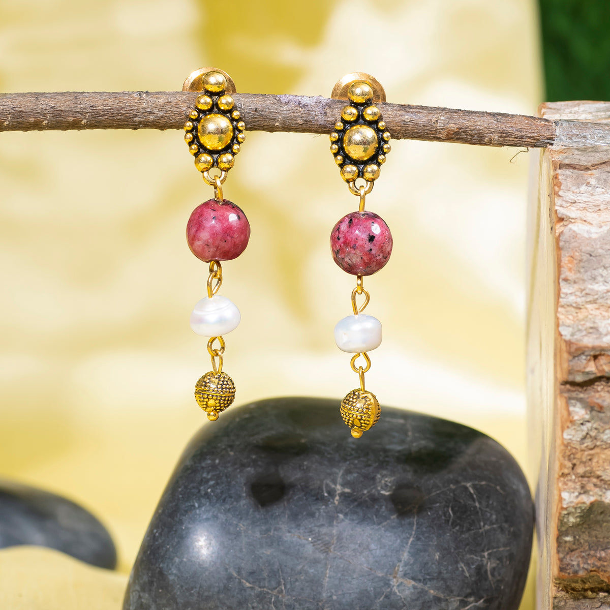 Eykaa Dalmatian and Freshwater Pearl Earrings hanging on the tree branch.