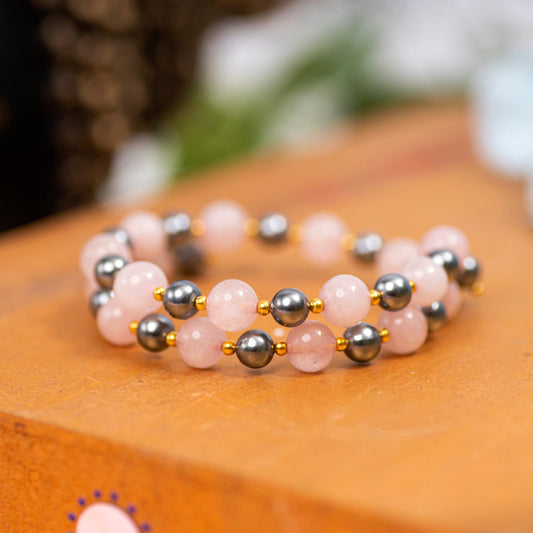   Eykaa Rose Quartz And Shell Pearl  Bracelet Displayed On A Textured Orange Surface.