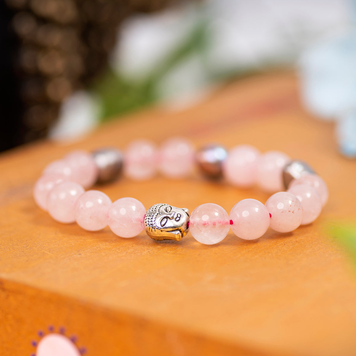  Eykaa Rose Quartz, Jade, And Freshwater Pearl Bracelet Displayed On A Textured Orange Surface.