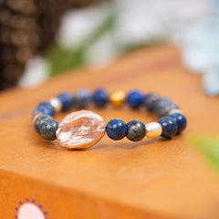  Eykaa Lapis Lazuli, Freshwater Pearl, And Jade Bracelet Displayed On A Textured Orange Surface.