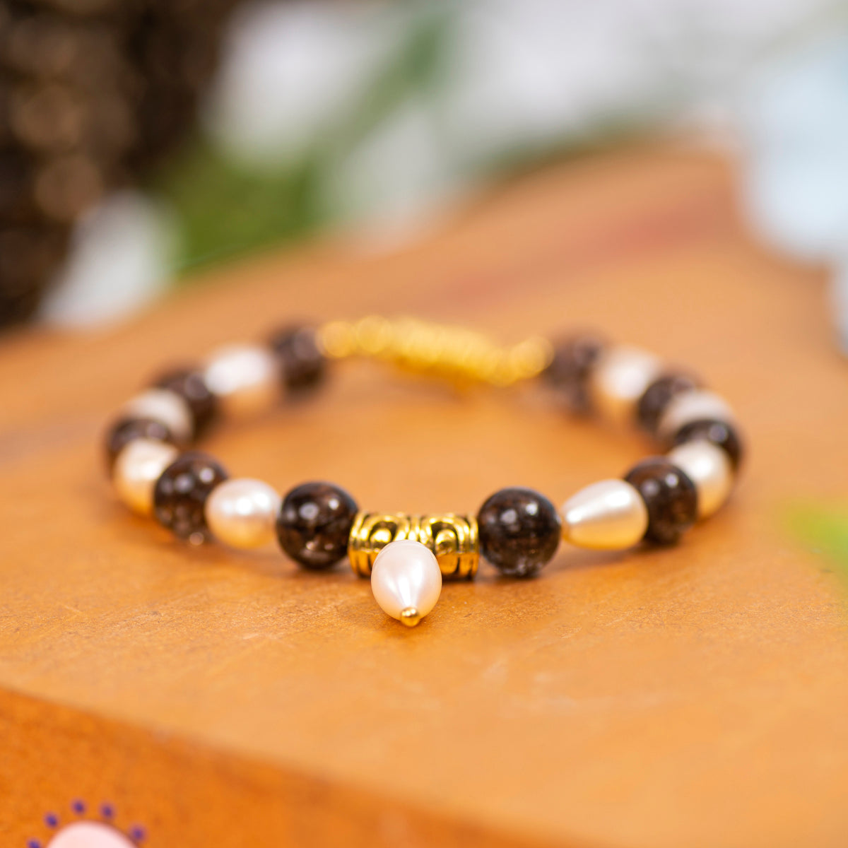 Eykaa Smokey Quartz And Fresh Water Pearl Bracelet on a smooth wooden surface.