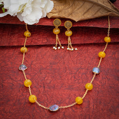 Eykaa Yellow Agate With Freshwater Pearl Necklace And Earrings On A Textured Red Background With White Flowers.
