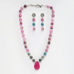 Eykaa necklace and earrings that feature pink jade, blue apatite with pink agate  semi precious stones with white background.