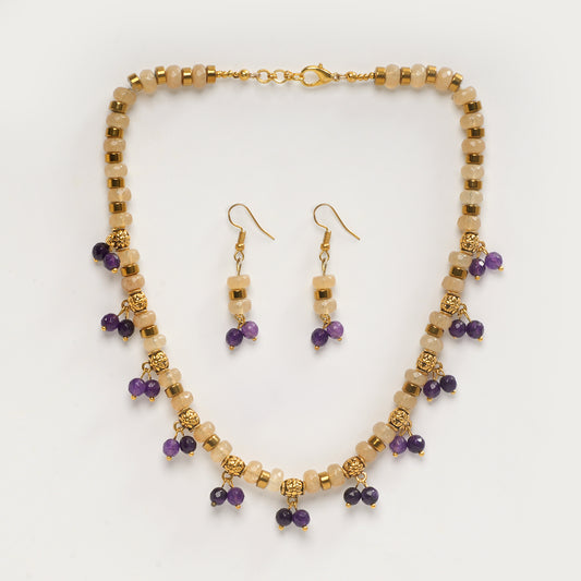 Eykaa yellow calcedonia, purple jade, and golden hematite semi precious stone necklace and earring on white background.