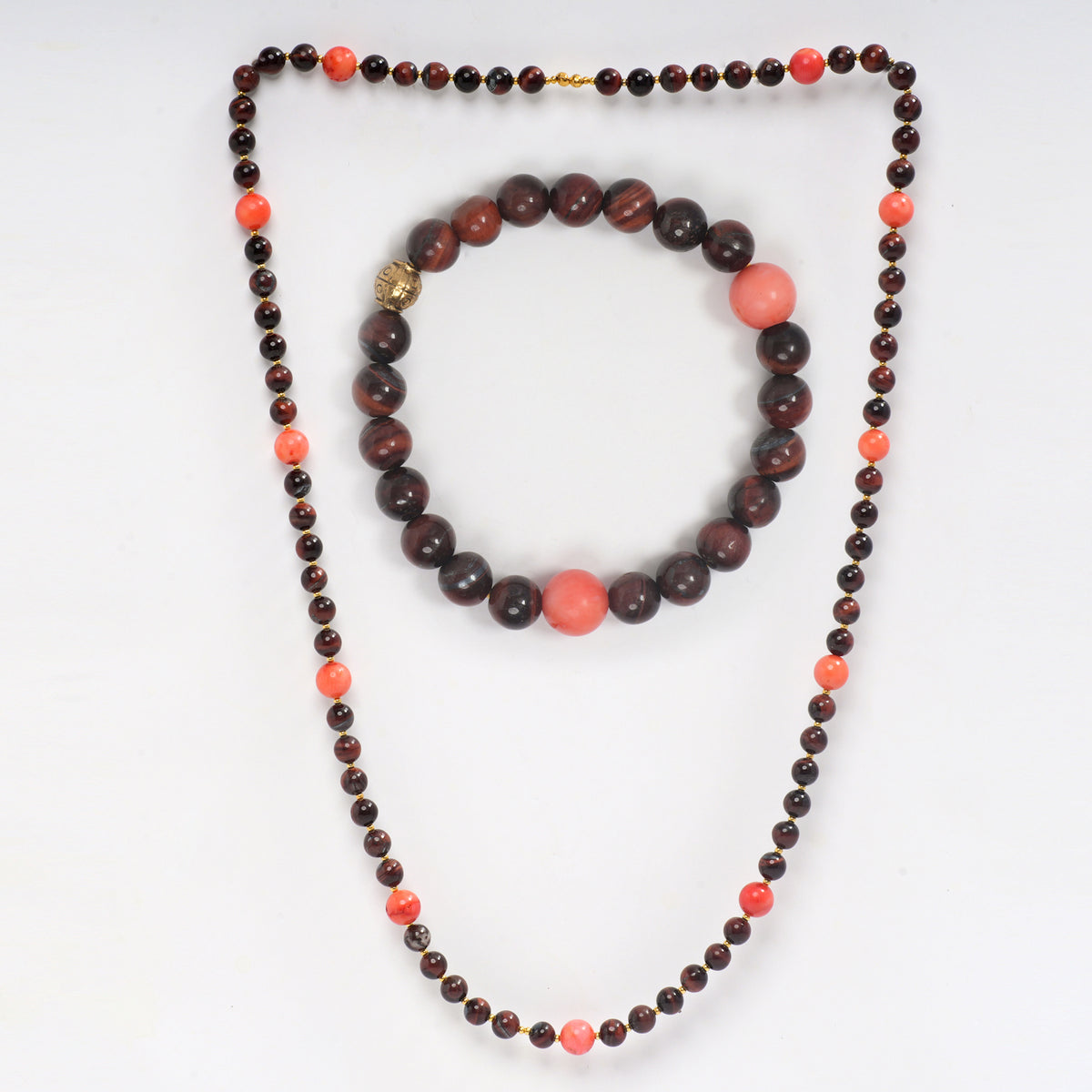 Eykaa Red Tiger Eye With Coral Necklace And A Bracelet On A White Background.