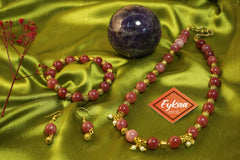 Eykaa EYKAA PINK JADE WITH SHELL PEARLS AND GOLDEN BEADS WITH GOLDEN CHARMS BRACELETon green satin cloth and Eykaa card