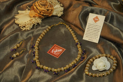 Eykaa yellow calcedonia, jade, and golden hematite semi precious stone necklace, earrings and bracelet on golden fabric.